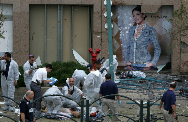 La policía israelí trata de identificar a las víctimas de un atacante suicida fuera de un centro comercial en Netanya (Israel, 2005).